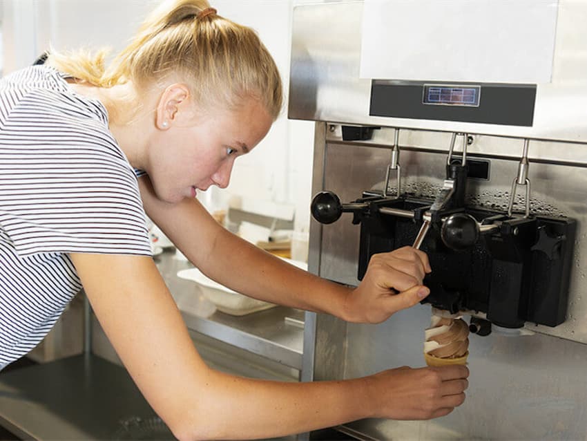 A girl running an Ice Cream Machine