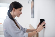 A girl checking Wireless Intruder Alarms UK